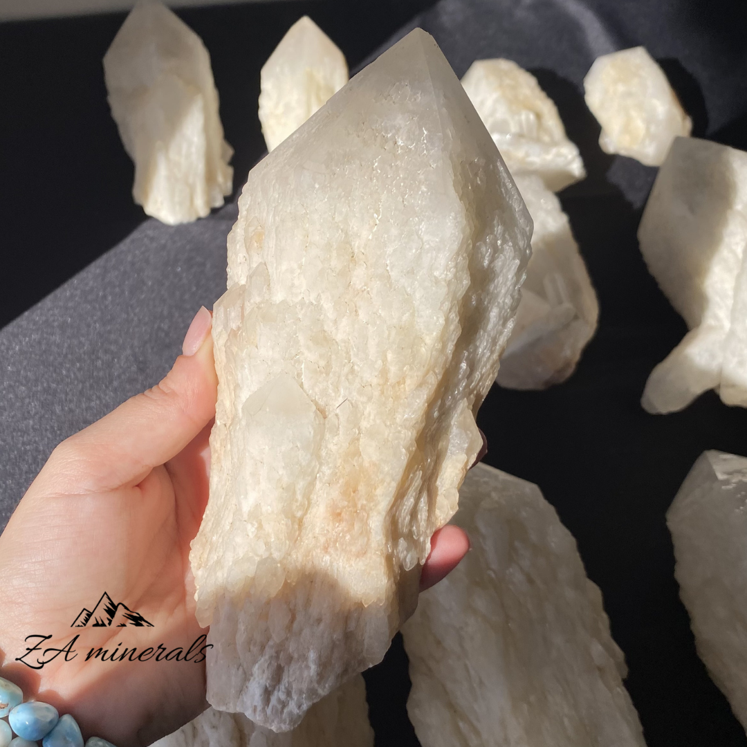 White Quartz crystal in hand for size reference