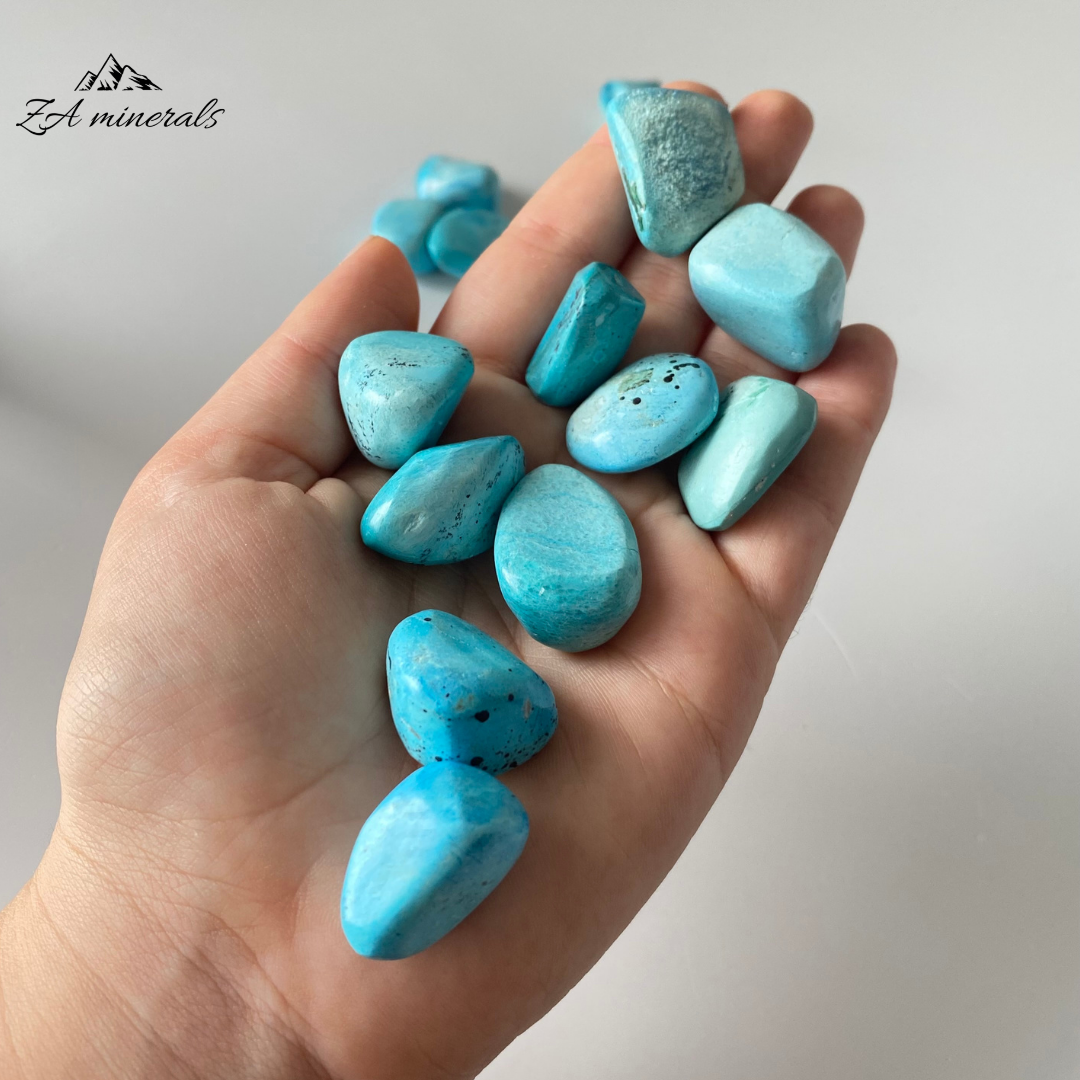 A copper magnesium silicate. A copper-bearing sepiolite or similar magnesium-rich clays species. Smooth, opaque, light blue-toned Chrysocolla pebbles. The blue tones of the Chrysocolla vary from white-blue to a vibrant saturated blue. All pebbles have been selected to be similar in size, perfect for gridding.