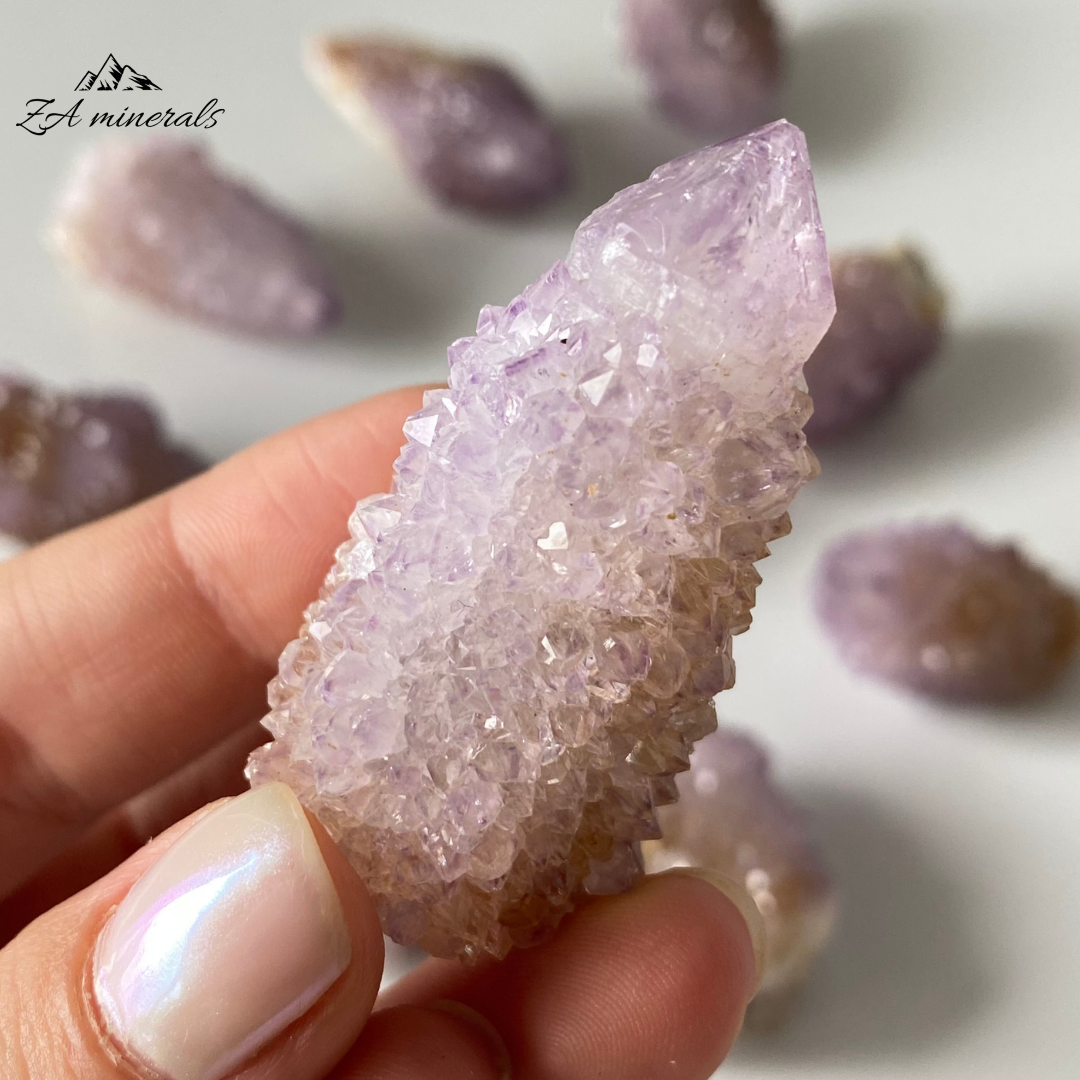 Prismatic Quartz terminations cover the first generation Quartz surface. Vibrant Lavender-purple colour of the Quartz. Lavender-purple zoning can be seen in the crystal terminations. Minor yellow iron staining Scattered chips and damage to the base and perimeter of the crystals.