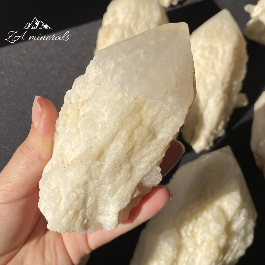 White Quartz crystal in hand for size reference 