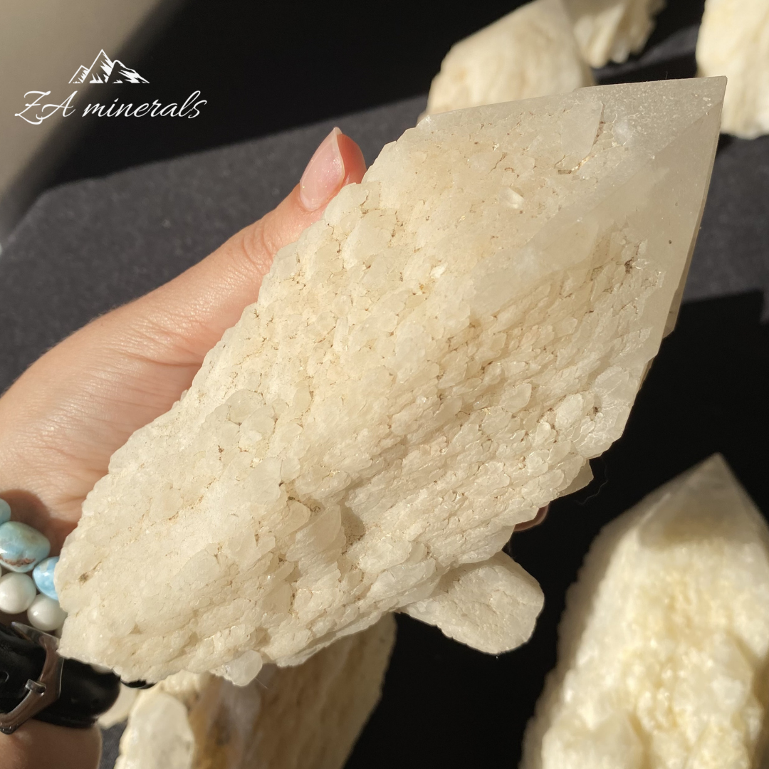 White Quartz crystal in hand for size reference 