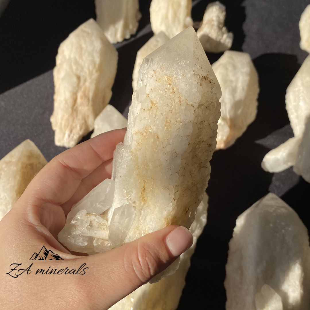 White Quartz crystal in hand for size reference 