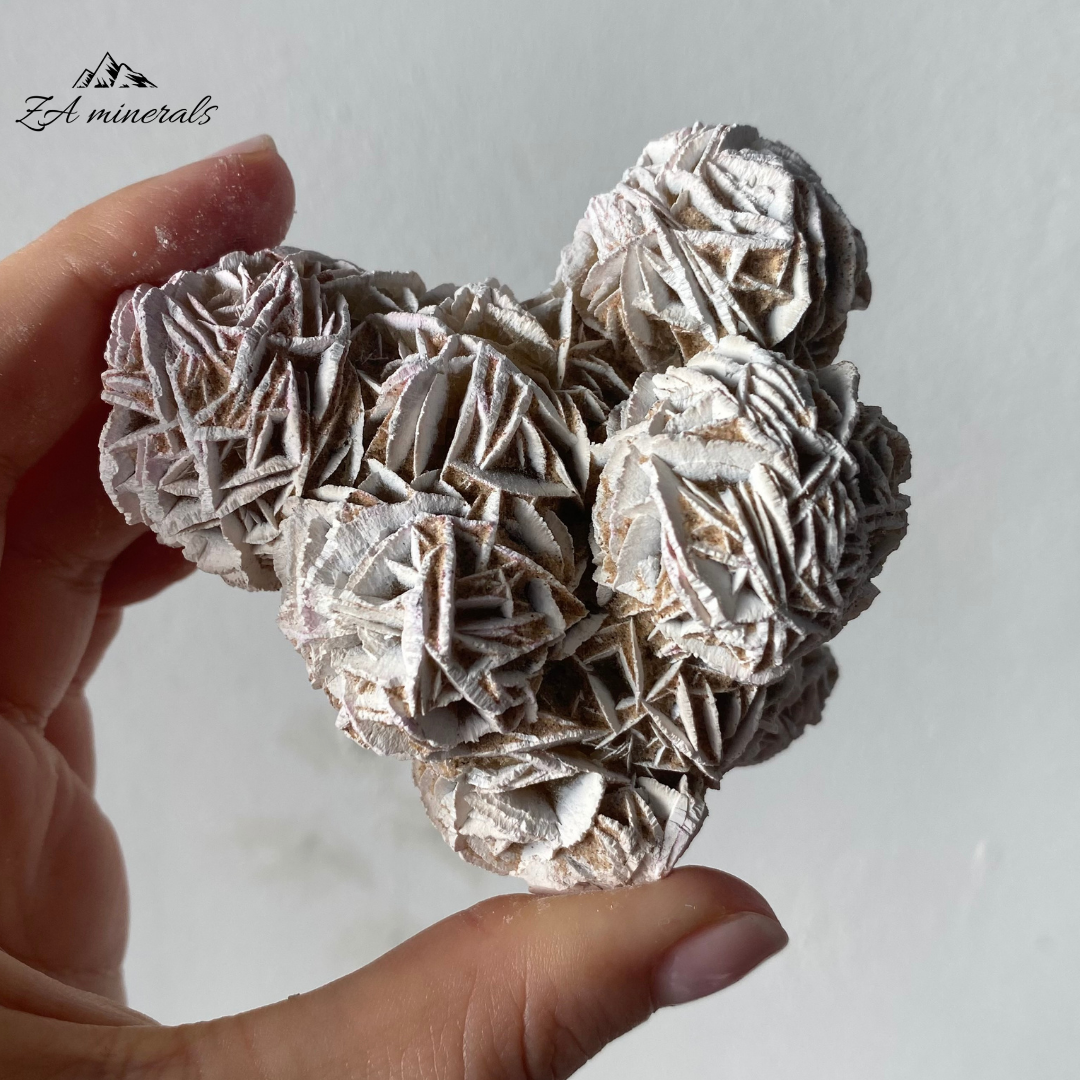 An eye catching and opaque Desert Rose cluster. The crystals grow in a flattened, plate-like structure that radiates out from a central point, creating a shape that resembles a rose blossom. Beautiful white edges due to heat treatment. Some of the blades are vitreous while most are matte. Sand grains are visible all over the piece.