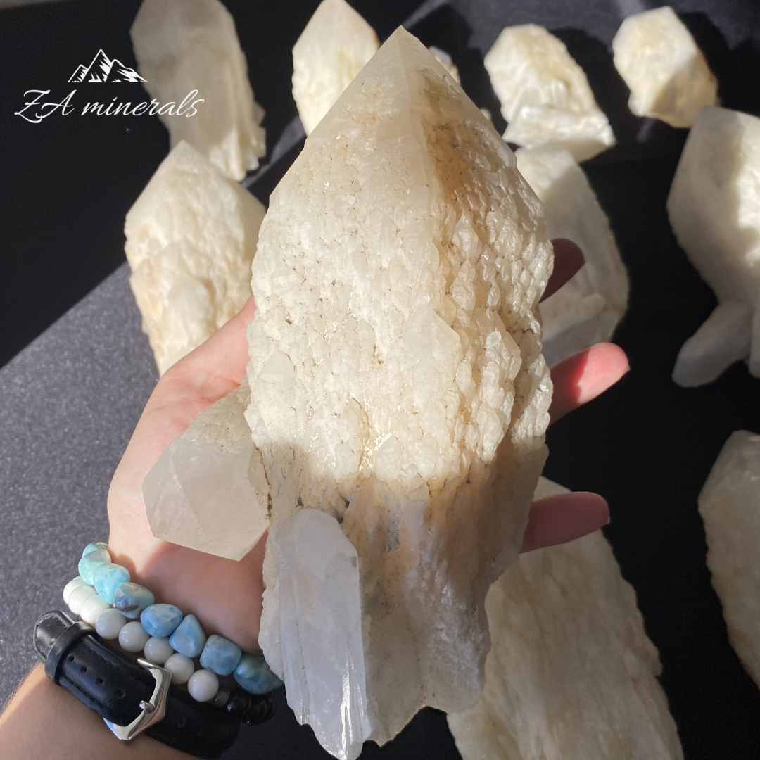 White Quartz crystal in hand for size reference 