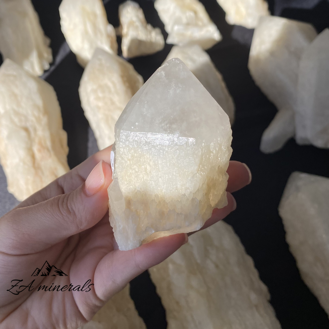 White Quartz crystal in hand for size reference 