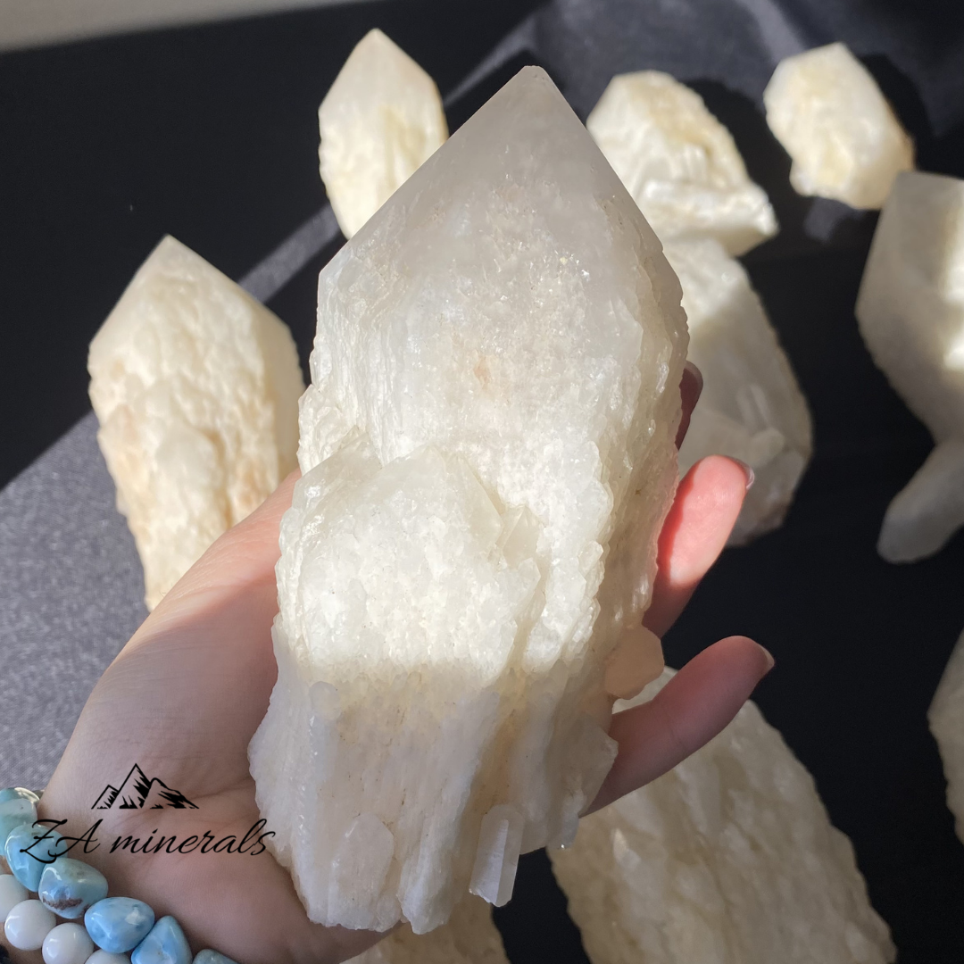 White Quartz crystal in hand for size reference 