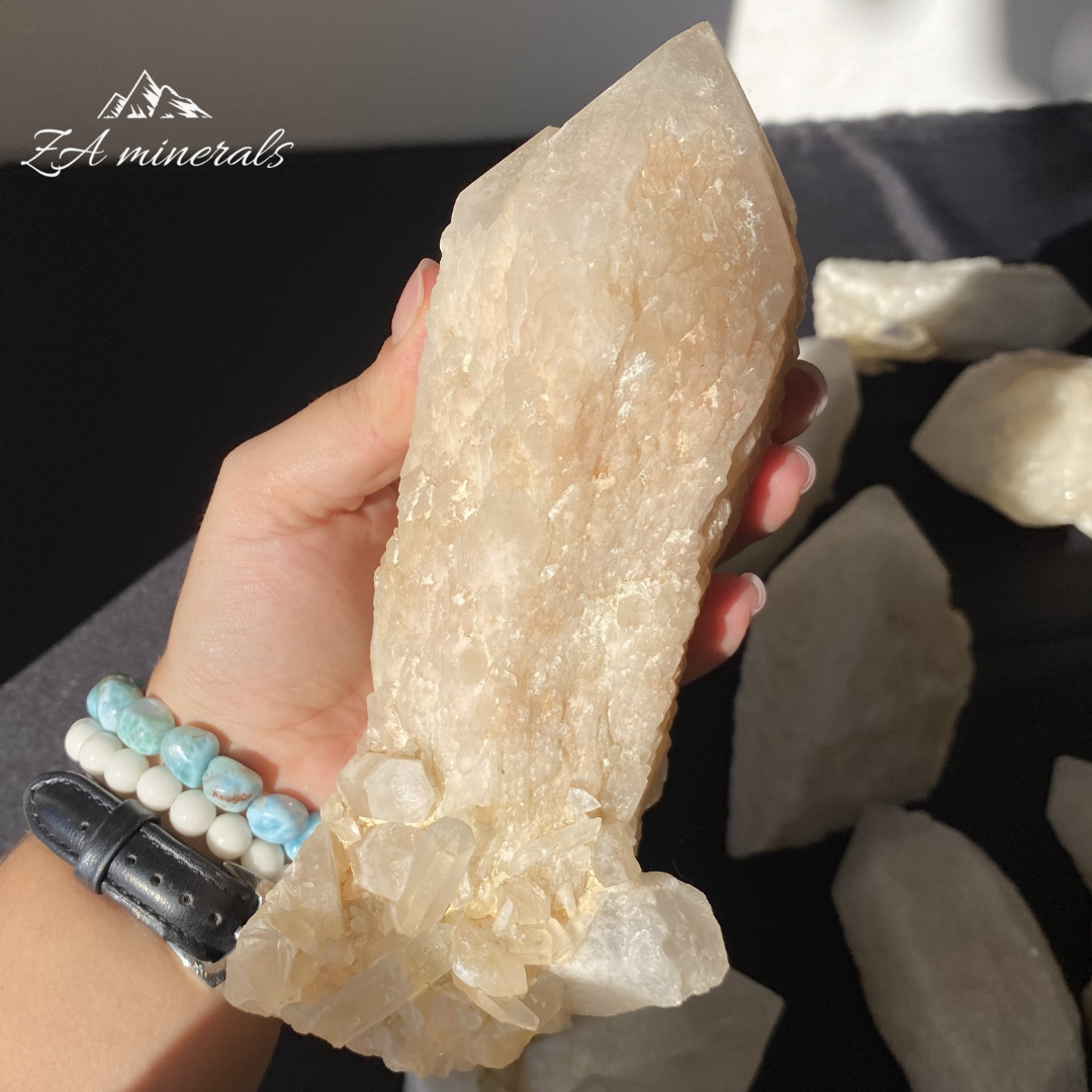 Large White Quartz crystal held in Hand