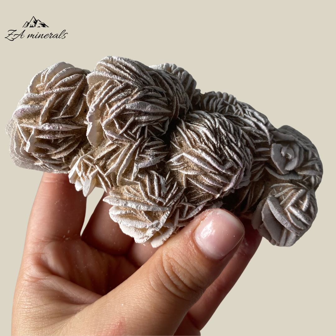 Large Cluster of densely intergrown rosettes of Desert Rose/ The gypsum crystals grow in a flattened, plate-like structure that radiates out from a central point, creating a shape that resembles a rose blossom.  Beautiful white edges due to heat treatment. Some of the blades are vitreous while most are matte. Sand grains are visible all over the piece.