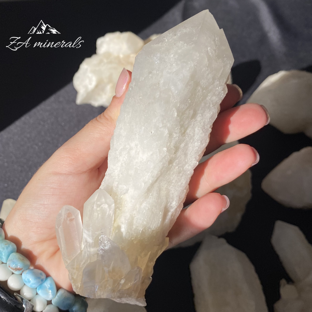 Large White Quartz crystal held in Hand