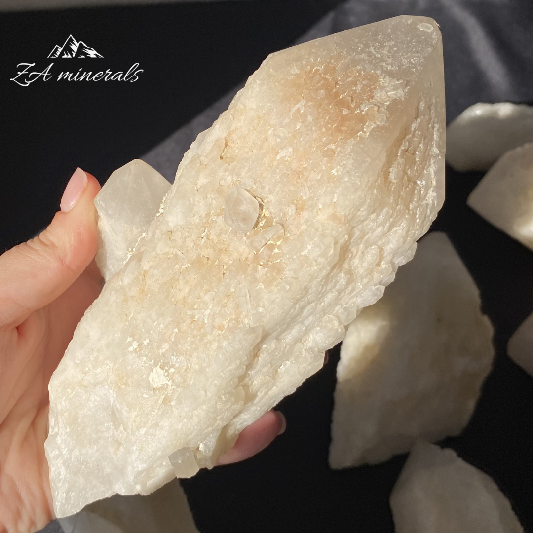 Large White Quartz crystal held in Hand