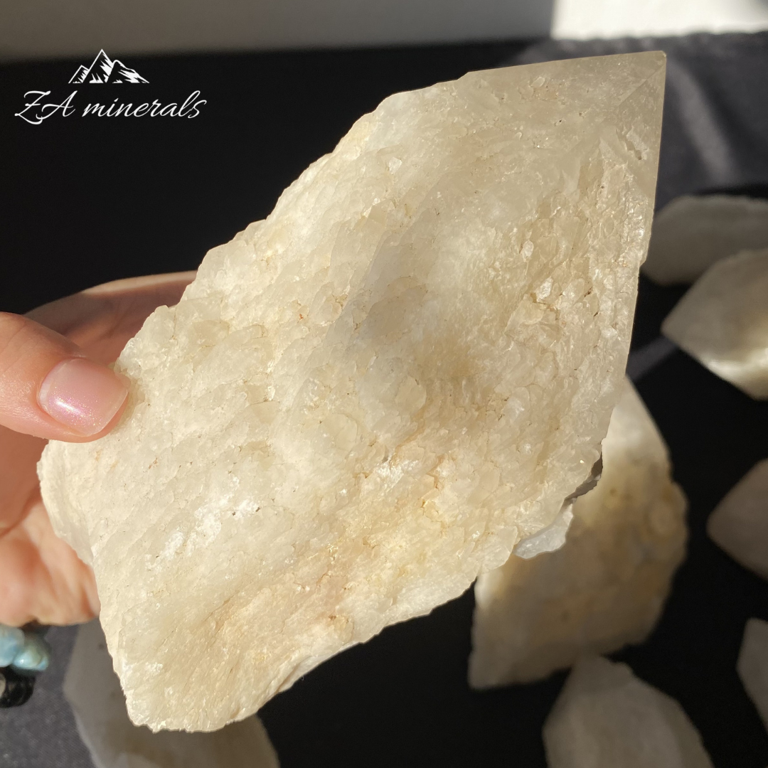 Large White Quartz crystal held in Hand