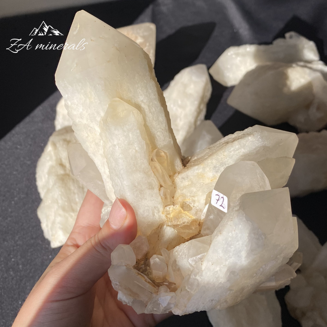 Large White Quartz crystal cluster held in Hand
