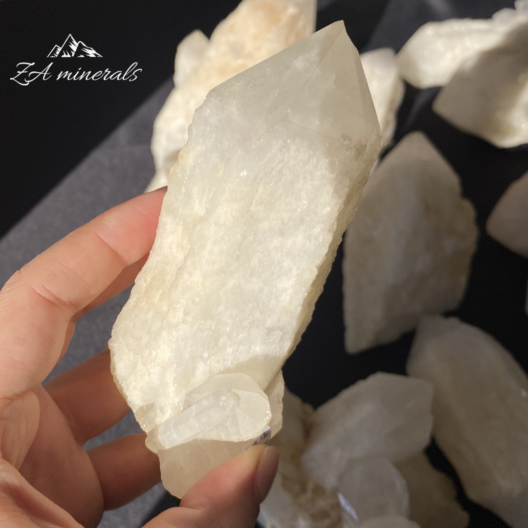 Large White Quartz crystal held in Hand