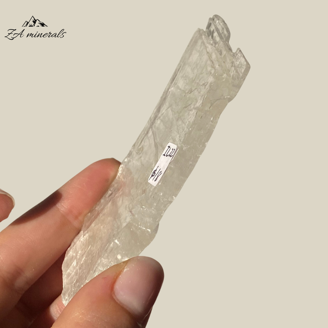 An amazing specimen of transparent and vitreous Selenite.  Striations and internal stress can be seen inside the piece. The edges of the slice are rough. Rainbow inclusions can be seen in between the layers of the Selenite.