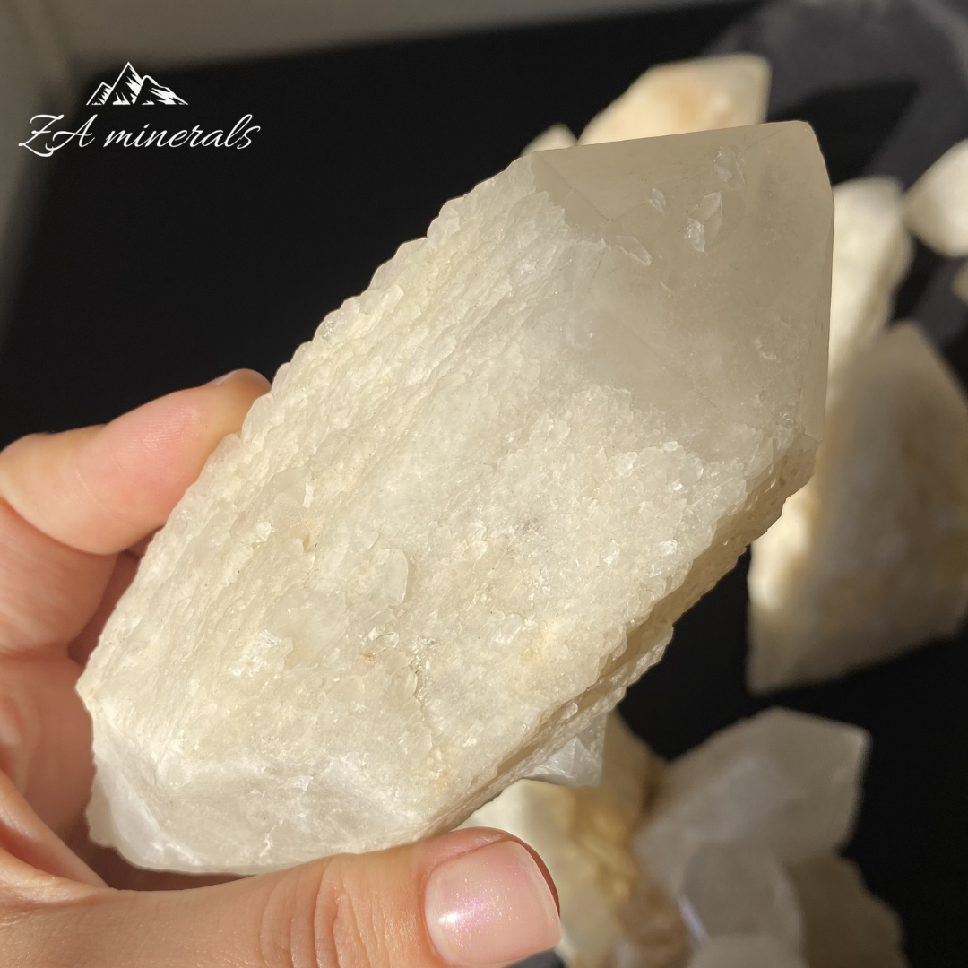 Large White Quartz crystal held in Hand