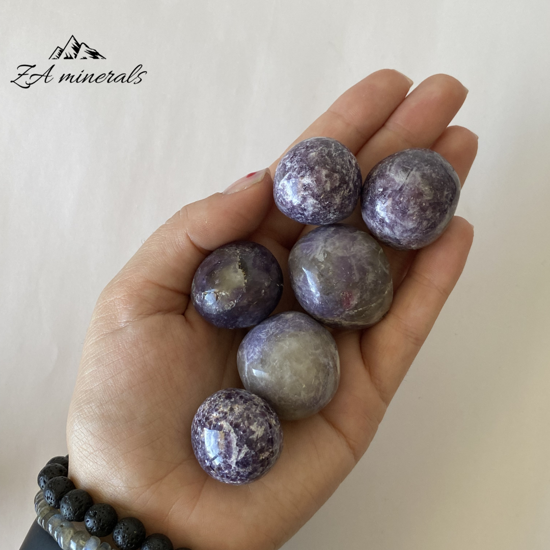 Size reference of Lepidolite gumballs in hand