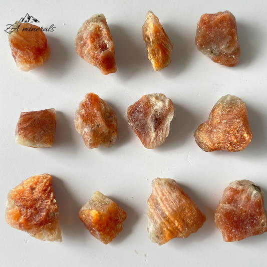A variety of feldspar (microcline or oligoclase) that has schiller, commonly with an orange/brown background color, due to exsolved oriented small hematite crystals that give it a flash and sparkle. These rough chunks of Sunstone have a matte luster. Subtle orange hue to the Sunstone chunks. When the sunstone is held at particular angles the vibrant Orange Schiller of the Sunstone can be seen. These are rough chunks and do not have a crystallized shape.