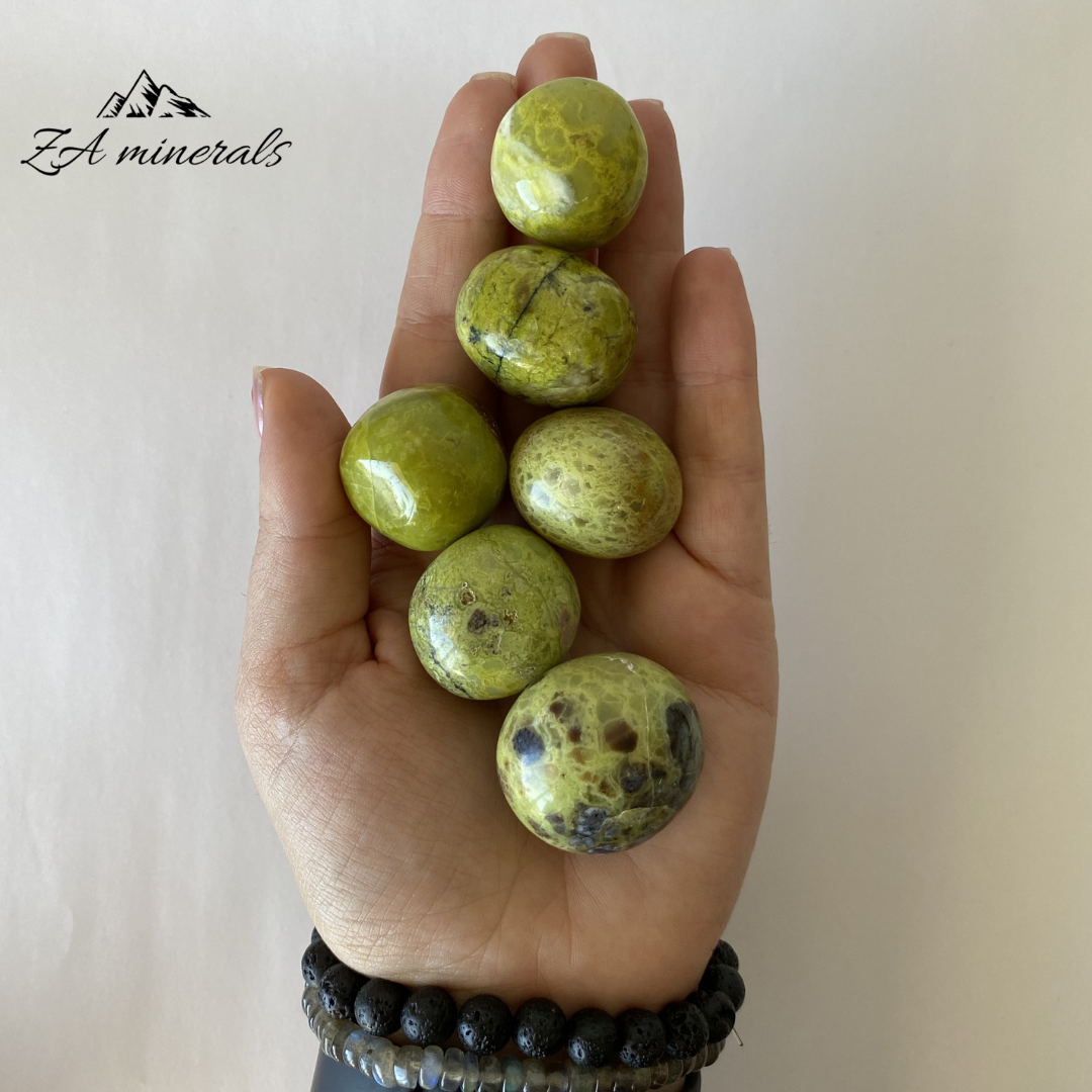 Size reference of green opal gumballs in hand 