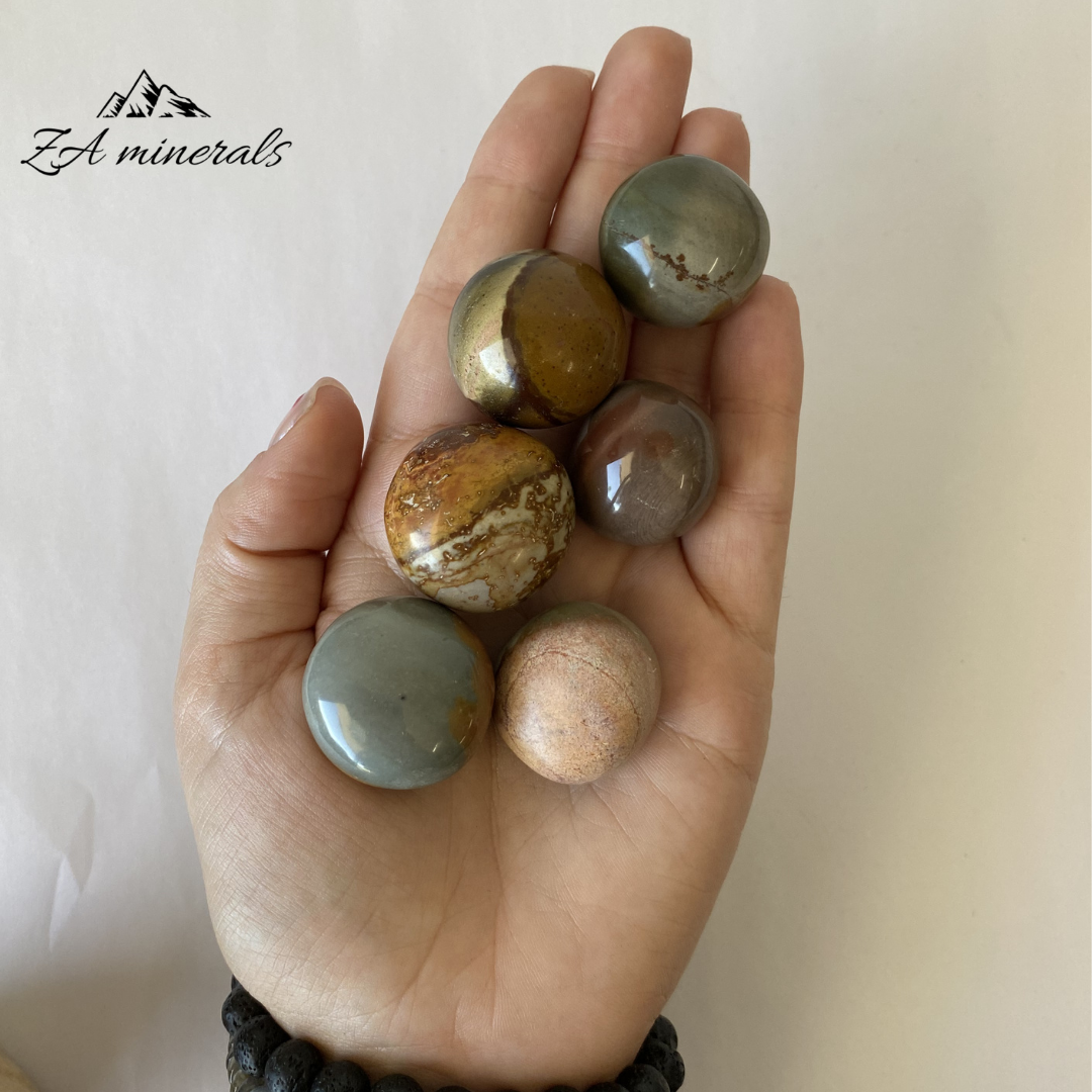 Size reference of polychrome jasper  gumballs in hand 
